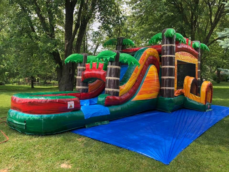 Large commercial inflatables like this inflatable water slide are pricier and more difficult to work with, but last forever if cared for properly. Note the use of a large commercial tarp set up underneath.